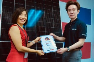 CEO Helen Ng presenting Service Star Award to Tan Yong Zhi